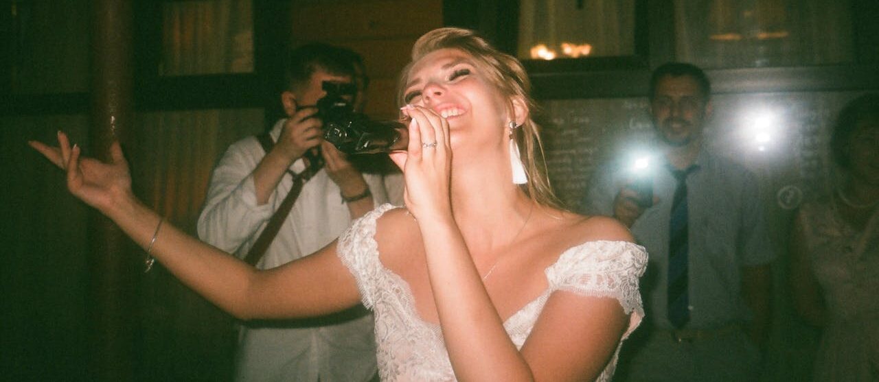 Woman Wearing White Dress While Singing